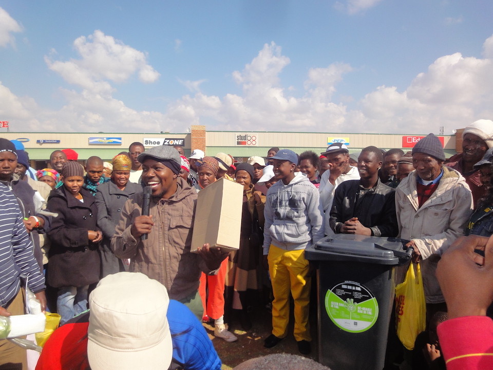 Trash, played by Luzuko Ngqetho, stays in character for a lucky prize draw during an activation in the hood